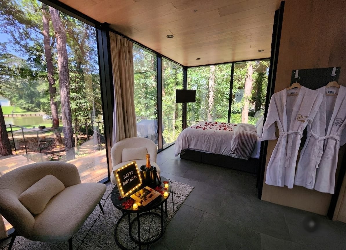 Birthday setup with glowing sign, chilled prosecco, chocolates, and plush robes in the Mirror House bedroom
