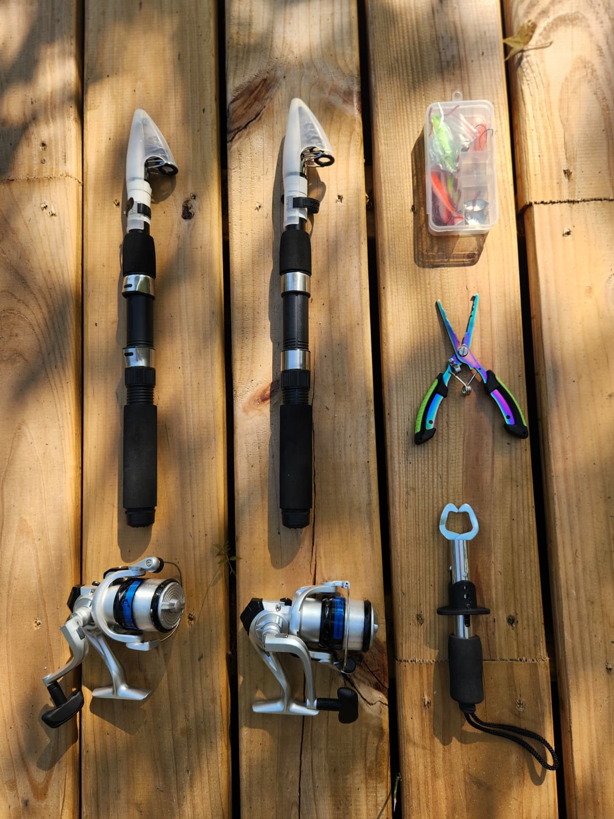Lake House Escapes fishing kit — two telescopic rods, tackle, pliers, and lip grip
